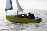 Mukti Mitchell makes a tack in the Explorer Microyacht, with Hartland Point in the background