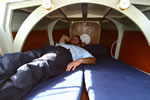 Room to stretch when lying down, Mukti Mitchell in the cabin of the Explorer Microyacht